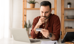 man with credit card at laptop